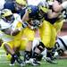 Michigan running back Drake Johnson carries the ball past linebacker Cameron Gordon during spring practice at Michigan Stadium on Saturday, April 13, 2013. Melanie Maxwell I AnnArbor.com